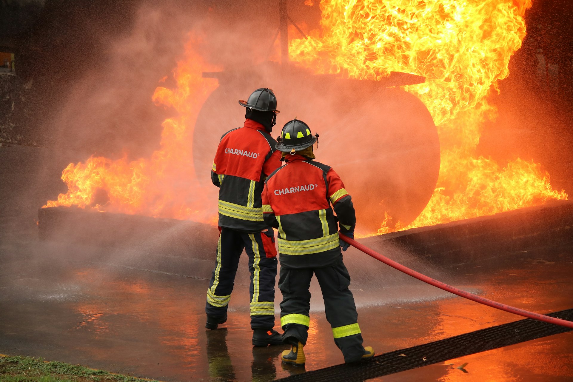 Firefighters battle a massive fire with flames.